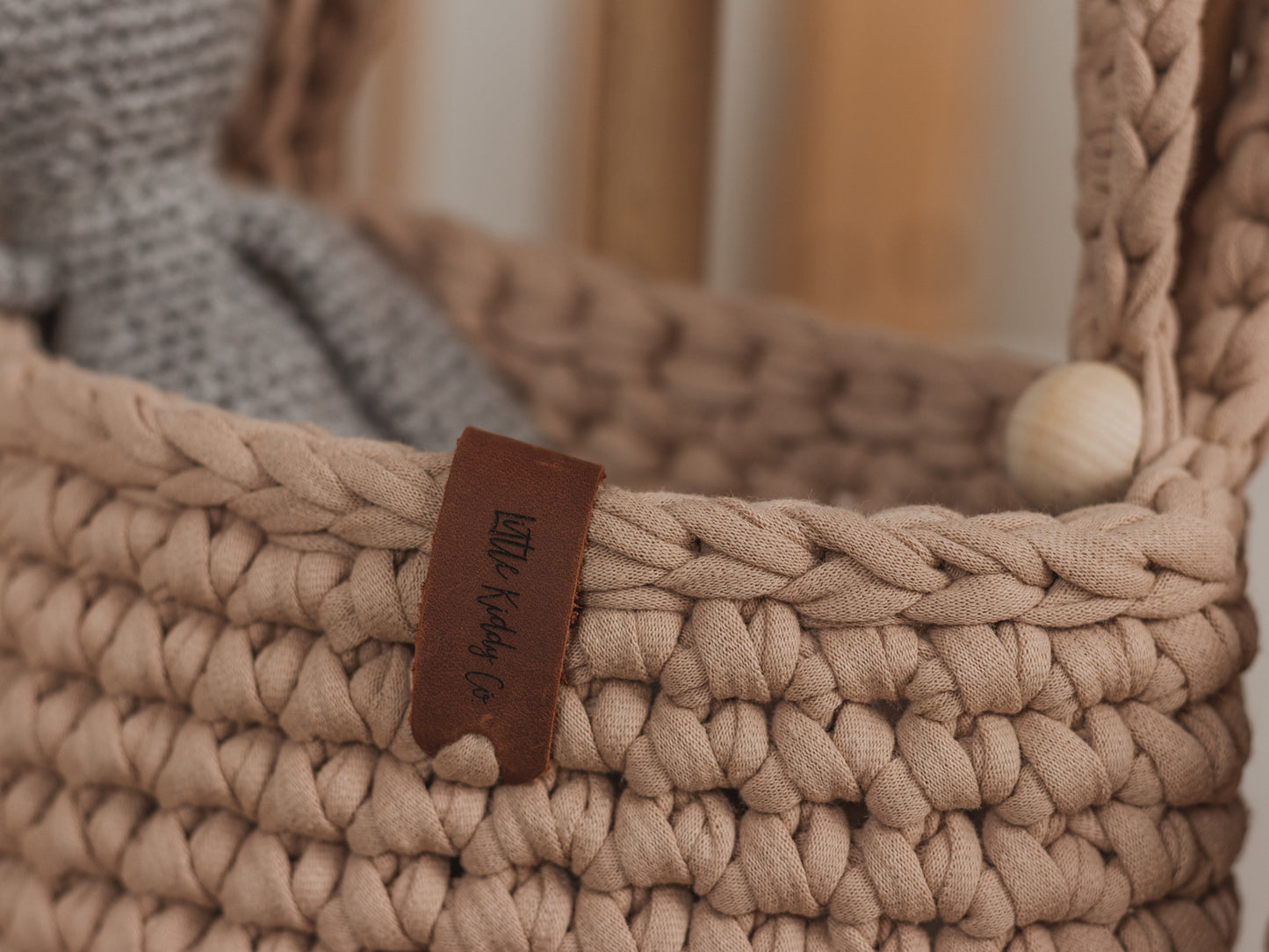 Woven basket with a leather tag displaying 'Wicker & Willow Co.'