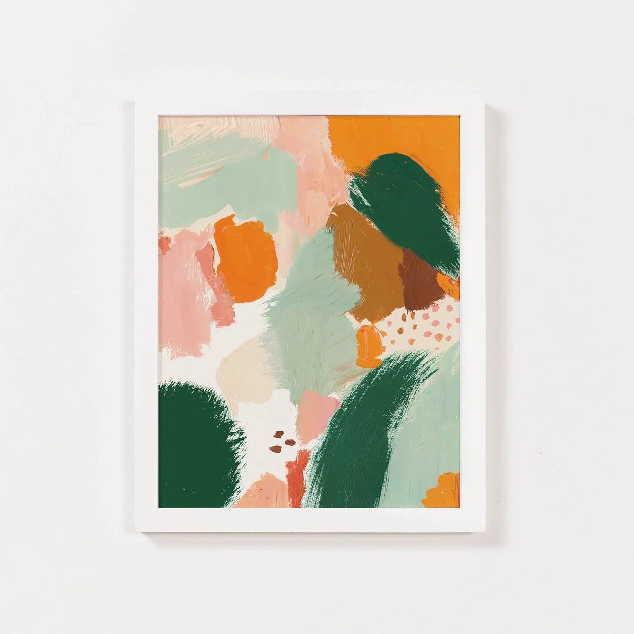 Framed abstract art print with colorful shapes on a white wall