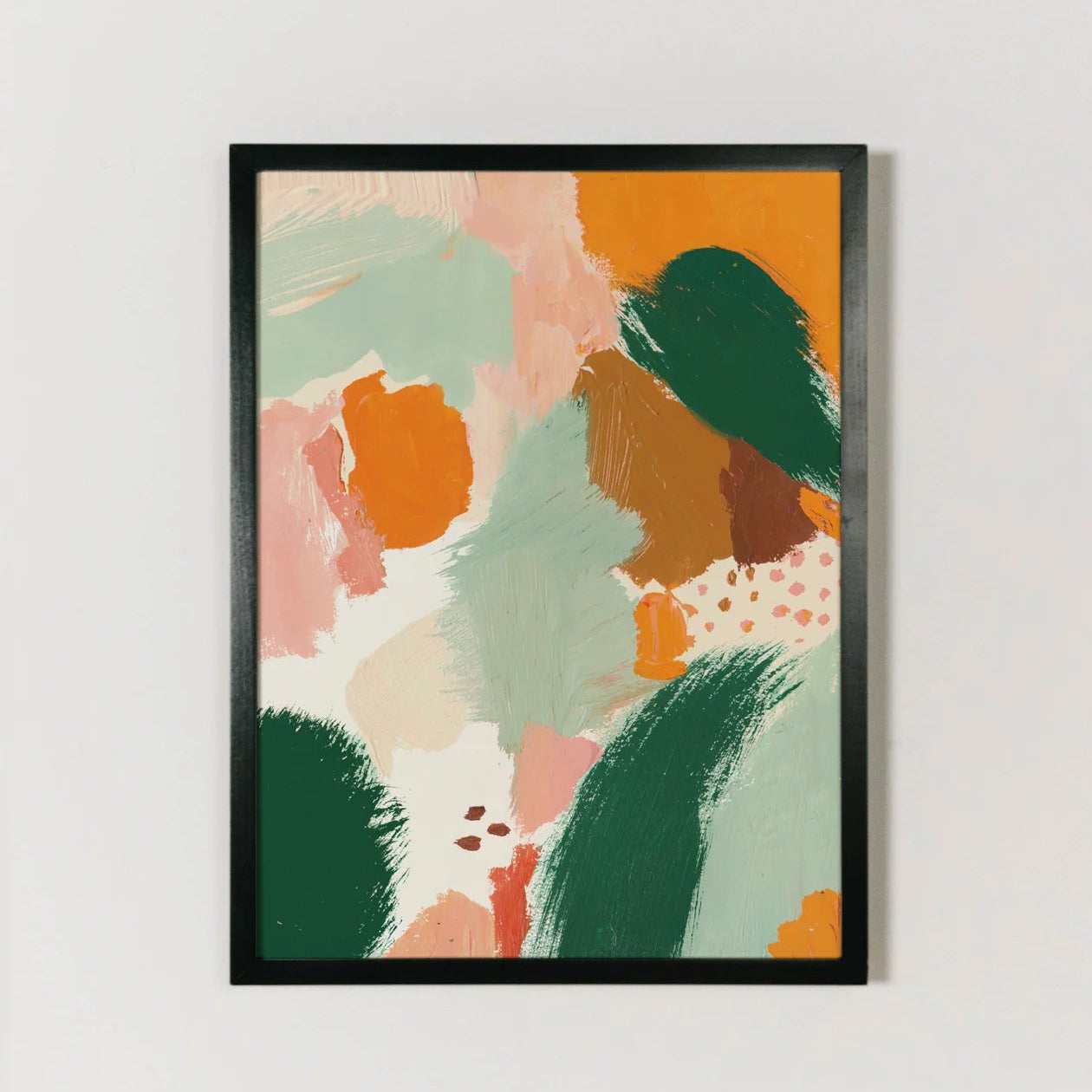 Framed abstract art print with colorful brush strokes on a white wall